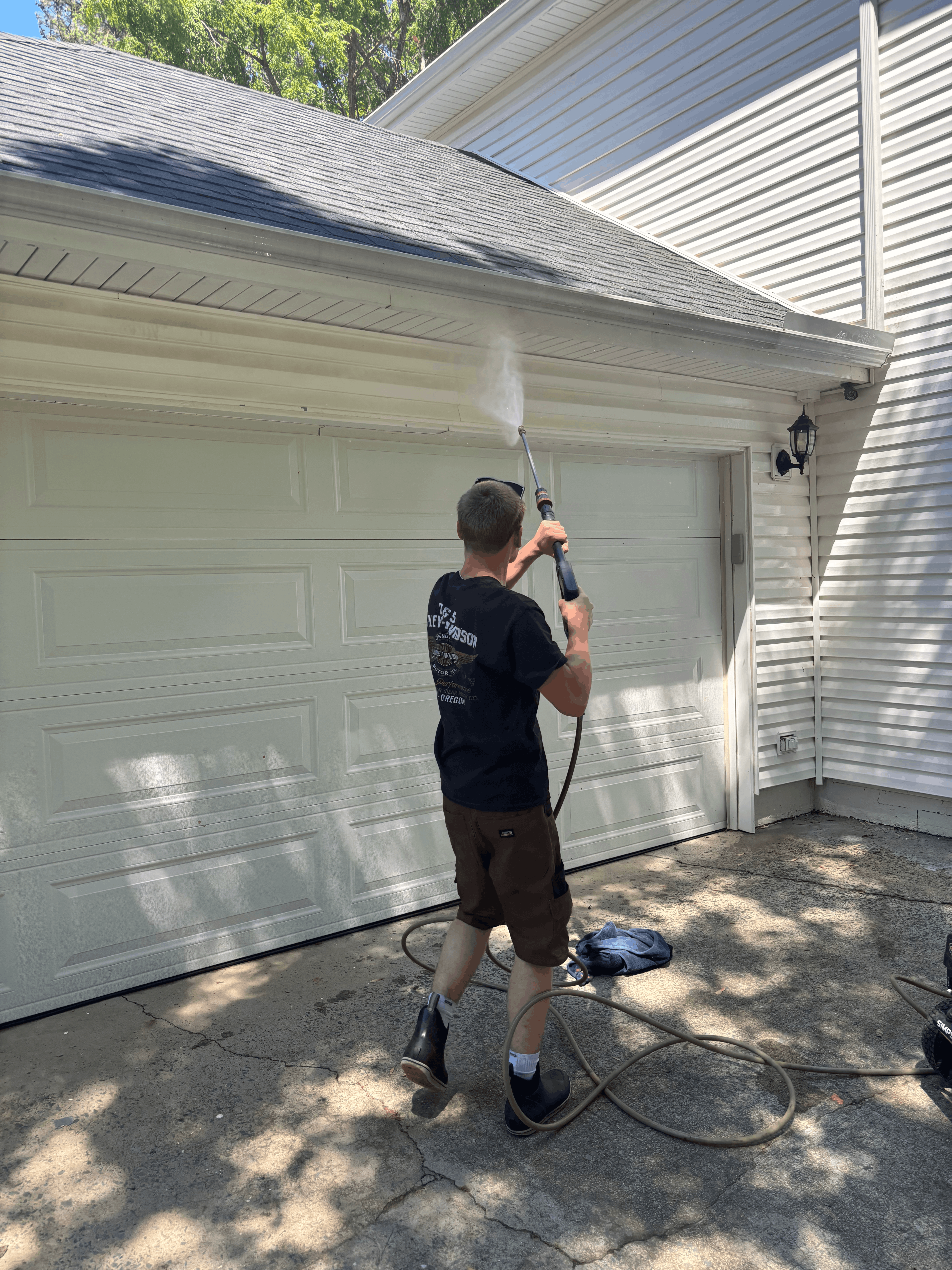 Powerwashing gutters above garage door